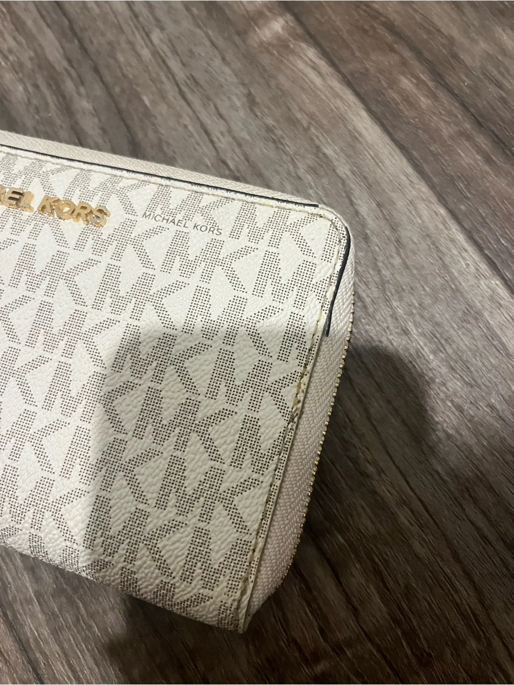 Michael Kors white and tan wallet, pealing on sides shown in photos